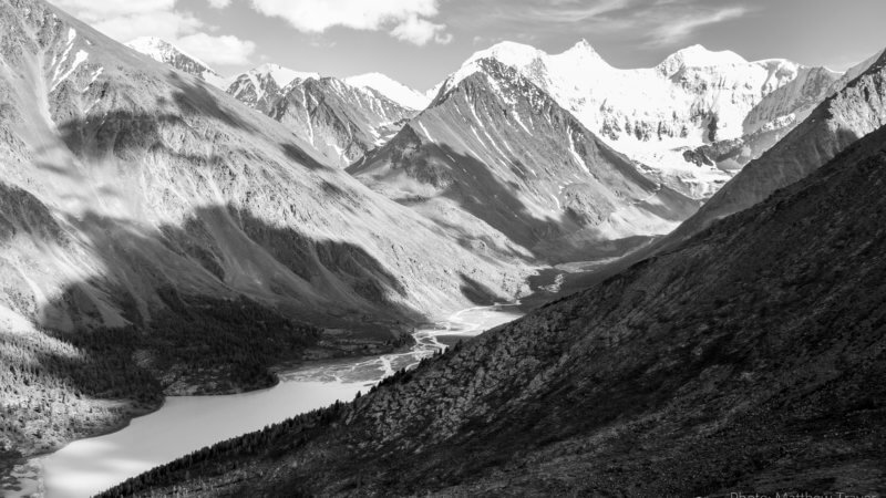 Black and white photo of clouds casting shadows on Mt. Belukha's main valley.