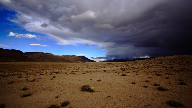 An enormous storm front passes over a stretch of desolate Pamir plateau.